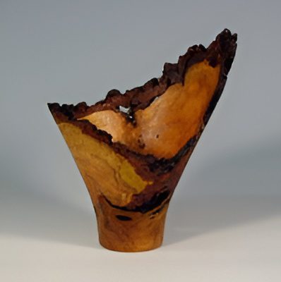 Artistic wooden vase with rough edges