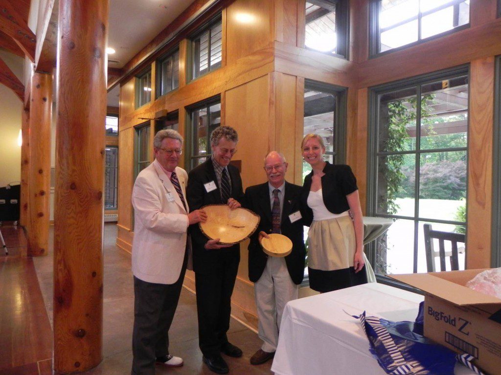 Four people smiling and posing